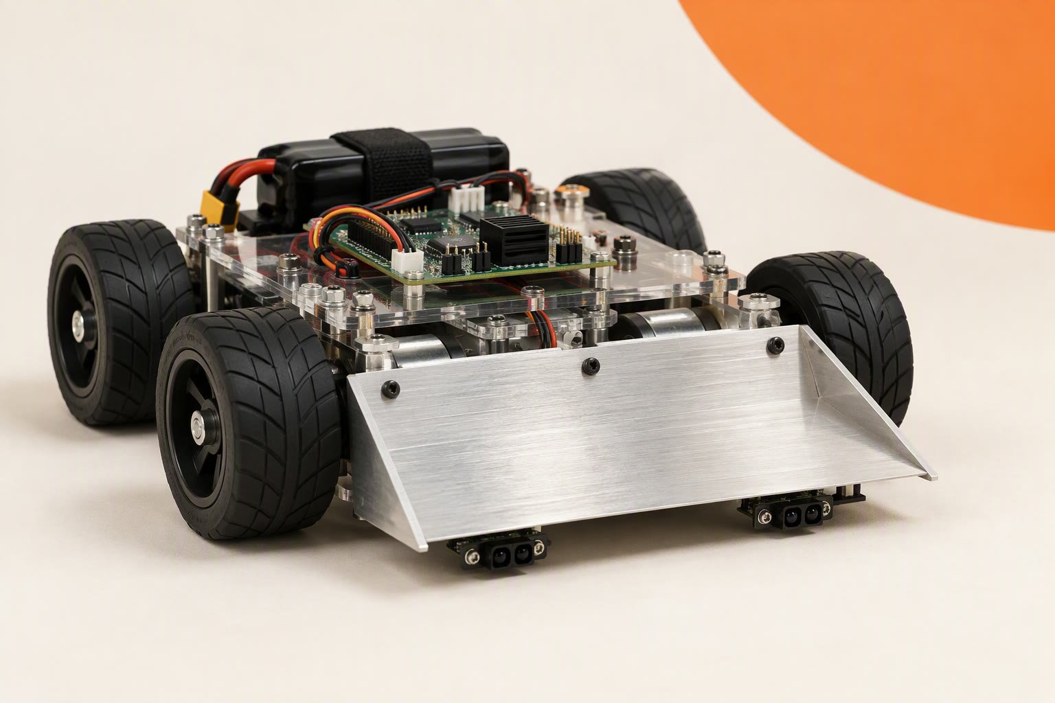Four-wheel sumo robot with a front scoop and reflectance sensors facing an opponent